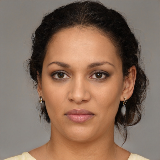 Joyful latino young-adult female with medium  brown hair and brown eyes