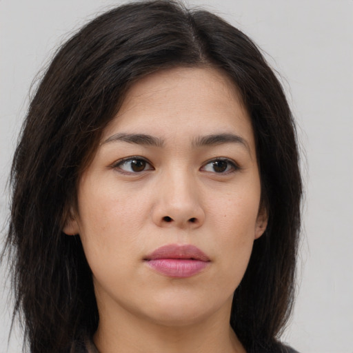 Joyful asian young-adult female with long  brown hair and brown eyes