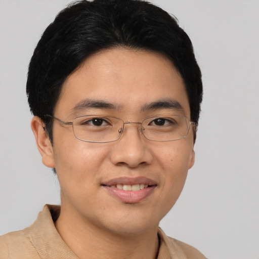 Joyful asian young-adult male with short  brown hair and brown eyes