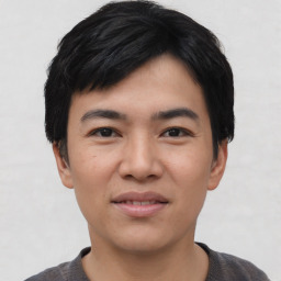 Joyful asian young-adult male with short  black hair and brown eyes