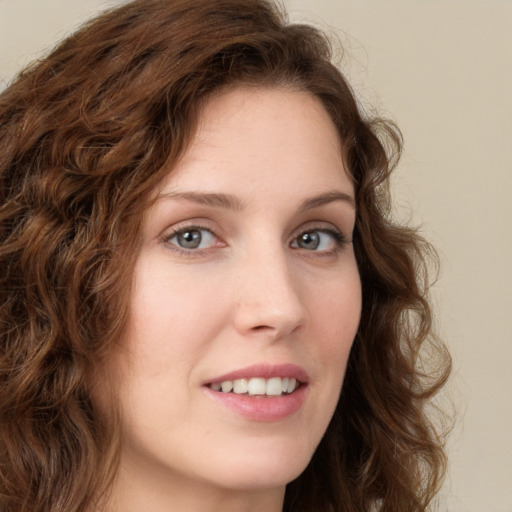 Joyful white young-adult female with long  brown hair and green eyes