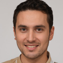 Joyful white young-adult male with short  brown hair and brown eyes