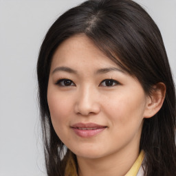 Joyful asian young-adult female with long  brown hair and brown eyes