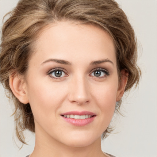 Joyful white young-adult female with medium  brown hair and green eyes