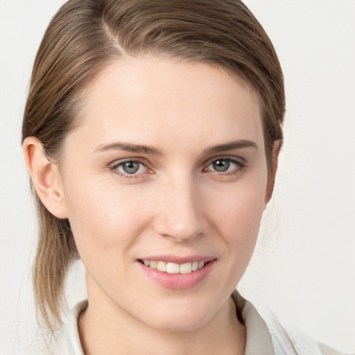 Joyful white young-adult female with medium  brown hair and grey eyes