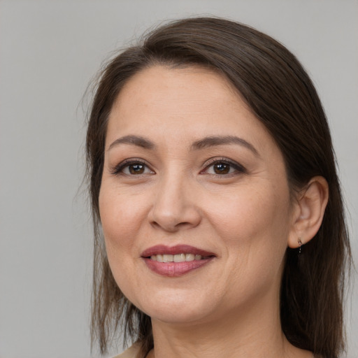 Joyful white adult female with medium  brown hair and brown eyes