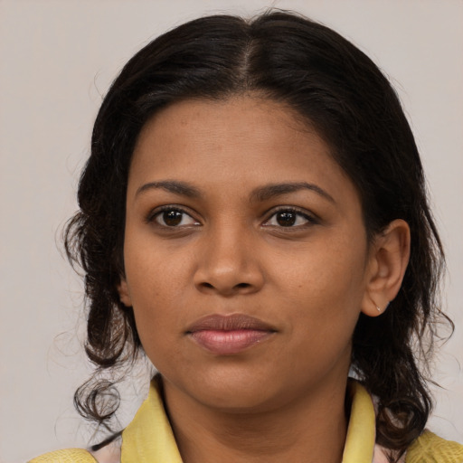 Joyful black young-adult female with medium  brown hair and brown eyes