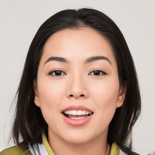 Joyful asian young-adult female with medium  black hair and brown eyes