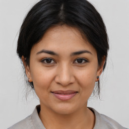 Joyful asian young-adult female with medium  brown hair and brown eyes