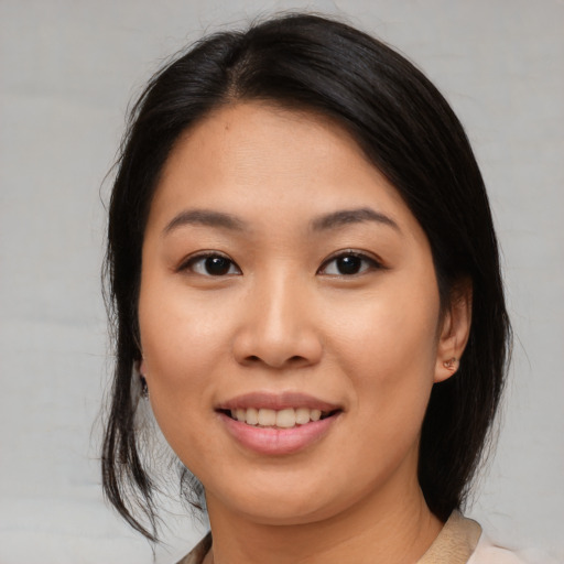 Joyful asian young-adult female with medium  brown hair and brown eyes