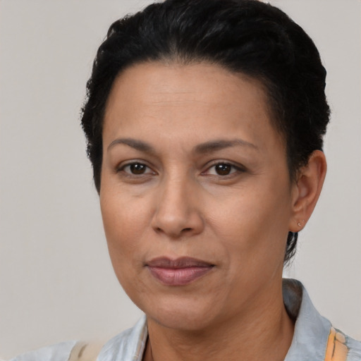 Joyful latino adult female with short  black hair and brown eyes