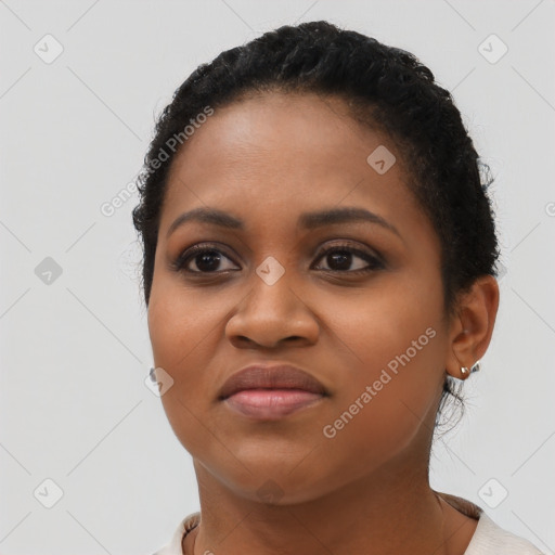 Joyful black young-adult female with short  brown hair and brown eyes