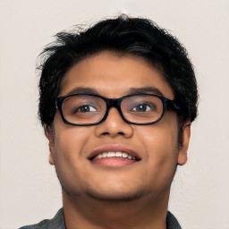 Joyful latino young-adult male with short  brown hair and brown eyes