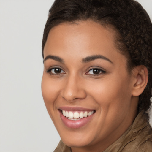 Joyful latino young-adult female with long  brown hair and brown eyes