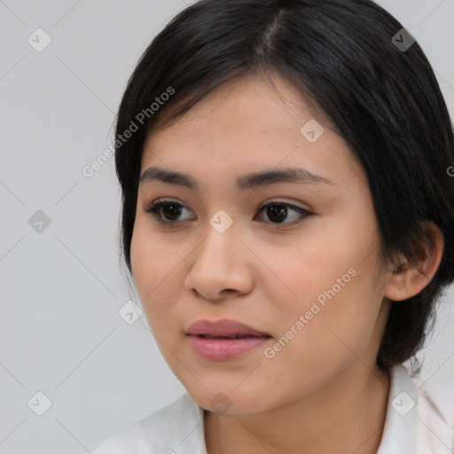 Joyful asian young-adult female with medium  brown hair and brown eyes