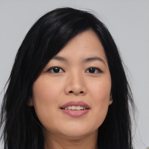 Joyful asian young-adult female with long  black hair and brown eyes