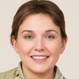 Joyful white young-adult female with medium  brown hair and grey eyes