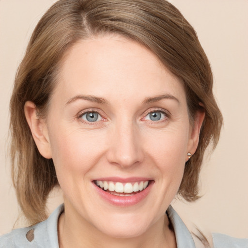 Joyful white young-adult female with medium  brown hair and blue eyes