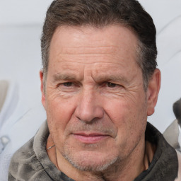 Joyful white middle-aged male with short  brown hair and brown eyes