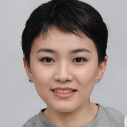 Joyful asian young-adult female with short  black hair and brown eyes