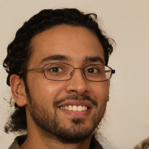 Joyful latino young-adult male with short  brown hair and brown eyes