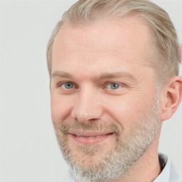 Joyful white adult male with short  brown hair and blue eyes