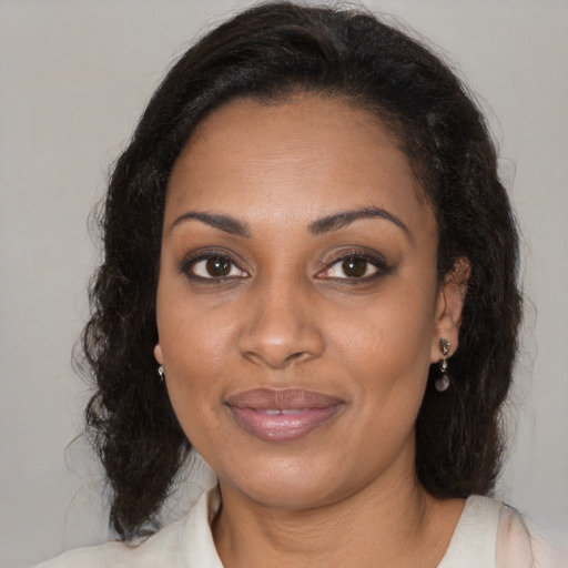 Joyful black young-adult female with medium  brown hair and brown eyes