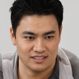 Joyful asian young-adult male with short  brown hair and brown eyes