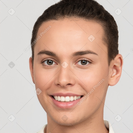 Joyful white young-adult female with short  brown hair and brown eyes