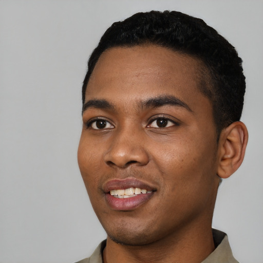 Joyful black young-adult male with short  black hair and brown eyes