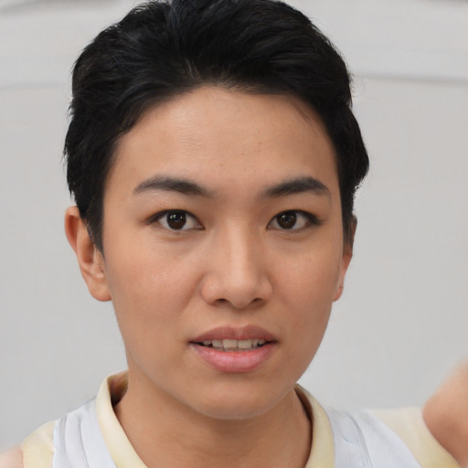 Joyful asian young-adult female with short  black hair and brown eyes