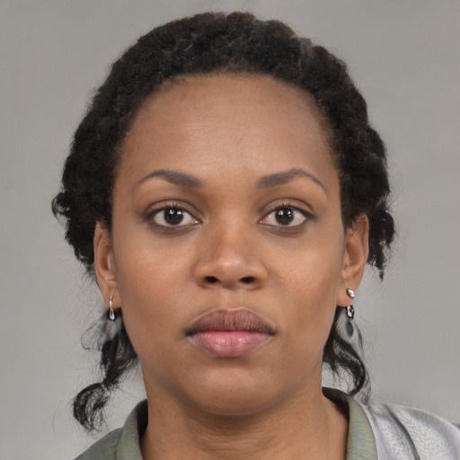 Neutral black young-adult female with medium  brown hair and brown eyes