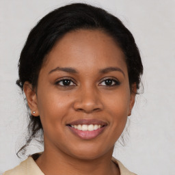 Joyful latino young-adult female with medium  brown hair and brown eyes