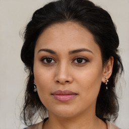 Joyful latino young-adult female with medium  brown hair and brown eyes