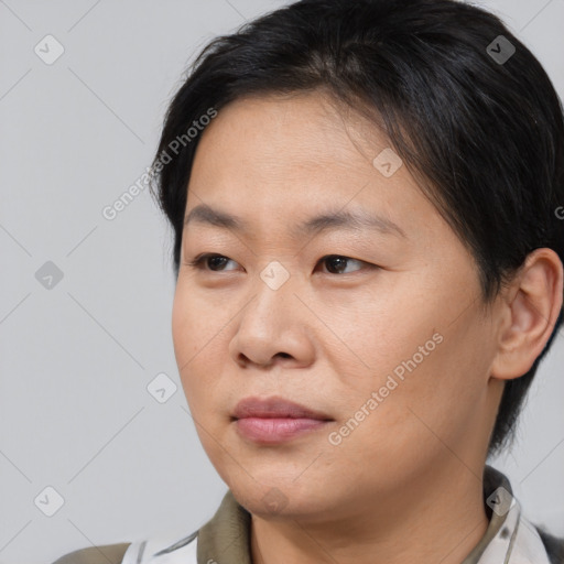 Joyful asian young-adult female with medium  brown hair and brown eyes