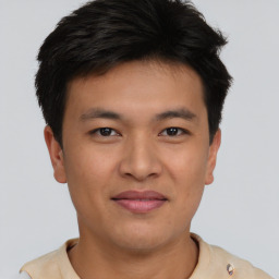 Joyful asian young-adult male with short  brown hair and brown eyes