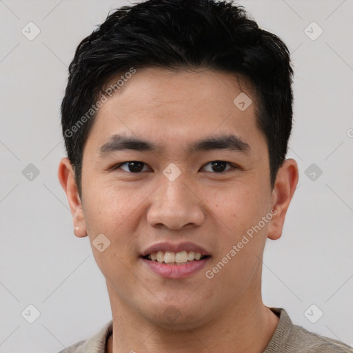 Joyful asian young-adult male with short  black hair and brown eyes