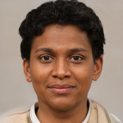 Joyful black young-adult male with short  brown hair and brown eyes