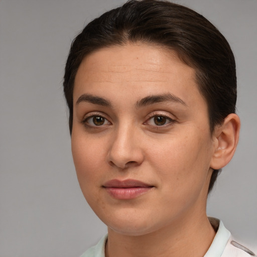 Joyful white young-adult female with short  brown hair and brown eyes