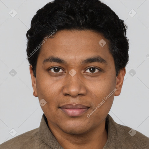 Joyful black young-adult male with short  black hair and brown eyes