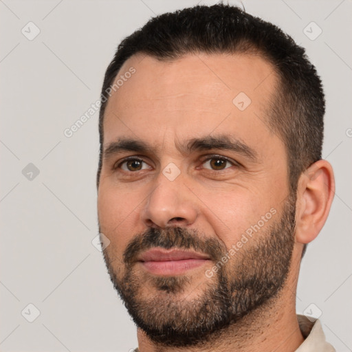 Joyful white adult male with short  black hair and brown eyes