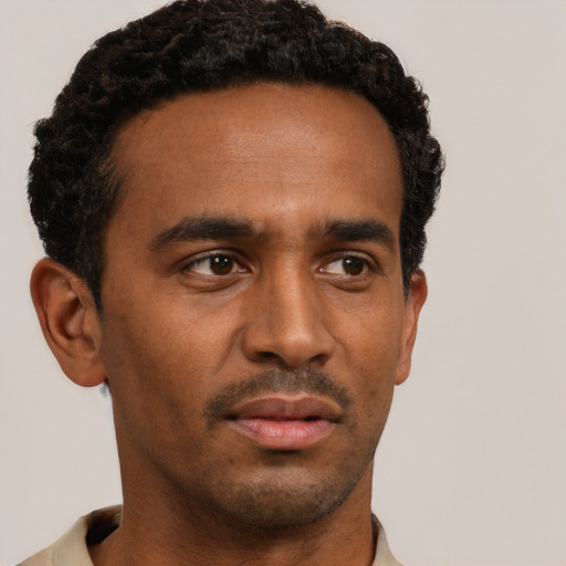 Neutral black young-adult male with short  black hair and brown eyes