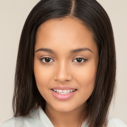 Joyful latino young-adult female with long  brown hair and brown eyes