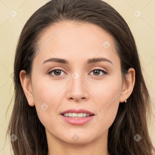 Joyful white young-adult female with long  brown hair and brown eyes