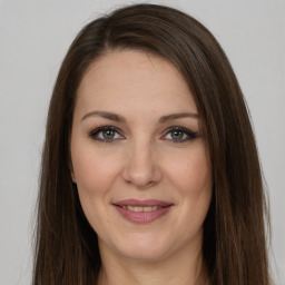 Joyful white adult female with long  brown hair and brown eyes