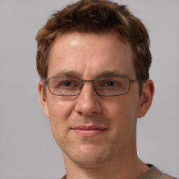 Joyful white adult male with short  brown hair and grey eyes