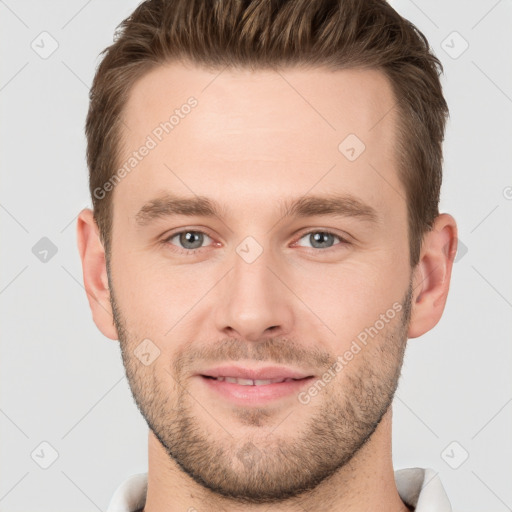 Joyful white young-adult male with short  brown hair and grey eyes