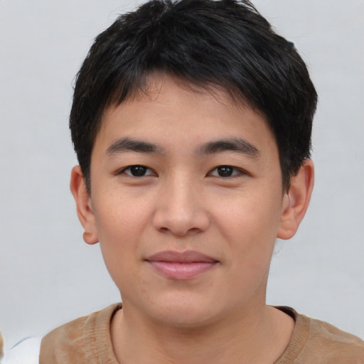 Joyful asian young-adult male with short  black hair and brown eyes