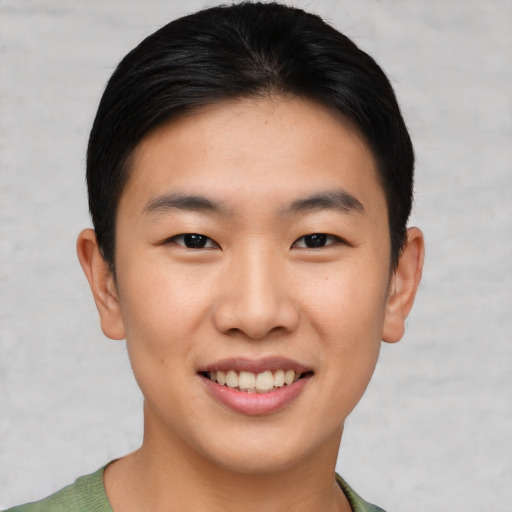 Joyful asian young-adult male with short  brown hair and brown eyes