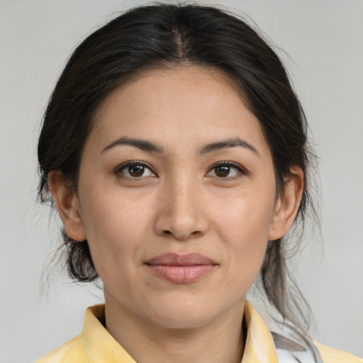 Joyful asian adult female with medium  brown hair and brown eyes